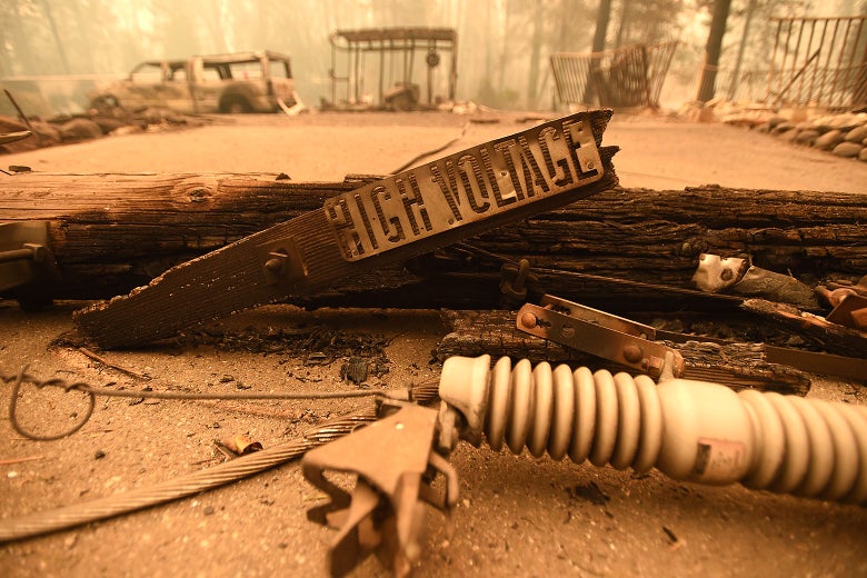 Scorched power lines and a sign reading high voltage.